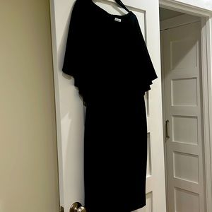 A black cape dress it is sleeveless with cape attached by Calvin Klein